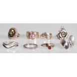 A selection of stamped 925 silver rings to include a ring set with a round cut pink stone, a wrap