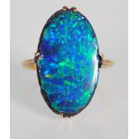 A 9ct gold and opal ring. The large opal doubled of oval form being basket mounted. Total weight 4.