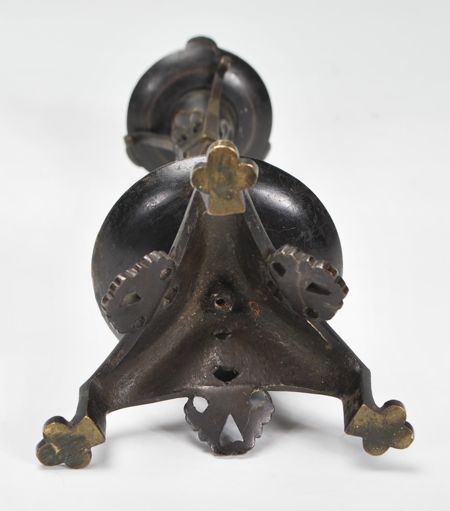 A late 19th / early 20th Century Arts and Crafts case bronzed candlestick raised on a tripod base - Image 6 of 7