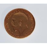 A 1911 full sovereign with George and the Dragon design and George V to verso. Weight 8.0g.