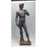 A 20th Century cast plaster sculptural figurine of Michelangelo's David having a black painted