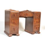 A 1930's Art Deco walnut twin pedestal office desk. Raised on plinth bases, each pedestal with an