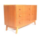 A retro teak wood mid century chest of drawers being raised on tapering angled legs with a bank of