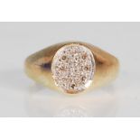 An English hallmarked 9ct gold ring having an oval head illusion set with white stones. Hallmarked
