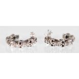 A pair of stamped 925 silver hoop earrings in the form of skulls with stud backs. Measures 2cm.