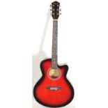 A 20th century Benson made six string electro-acoustic guitar. Finished in a red sunburst, with faux