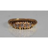 AN HALLMARKED 18CT GOLD AND DIAMOND 5 STONE RING