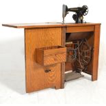 Singer sewing machine - An early 20th century Art Deco oak cased treadle Singer sewing machine