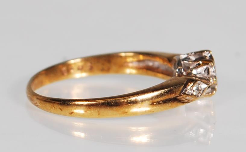 A hallmarked 9ct gold and diamond ring. The ring having a central diamond within a white and - Image 2 of 6