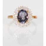 A 9ct gold hallmarked blueberry quartz and diamond cluster dress ring having a central cabochon