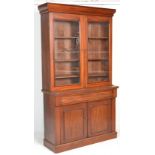 A large Victorian 19th century mahogany library bookcase cabinet. Raised on a plinth base with