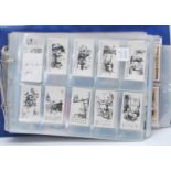 A collection of vintage 20th Century cigarette trade cards over an album containing full sets to