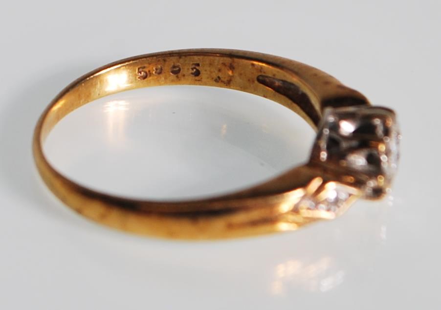 A hallmarked 9ct gold and diamond ring. The ring having a central diamond within a white and - Image 6 of 6