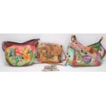 A selection of Anuschka leather handbags made from tan leather with hand applied coloured decoration