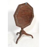 A 19th century mahogany tilt top breakfast  / loo table raised  on tripod base with splayed legs and