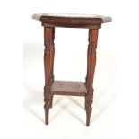 An early 20th Century carved Oak Empire occasional / side table, the circular top having ornate