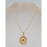 An 18 ct gold 20th century vintage pendant of oval form having pierced decoration rim set with a