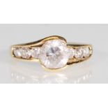 A hallmarked 14ct gold and CZ dress ring. The ring having a large round brilliant cut CZ flanked
