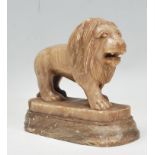 A 19th Century Victorian carved alabaster figurine in the form of a lion raised on a shades plinth