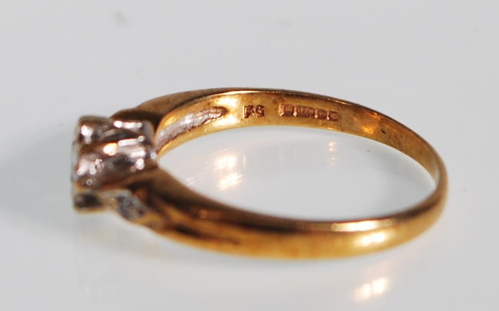 A hallmarked 9ct gold and diamond ring. The ring having a central diamond within a white and - Image 5 of 6