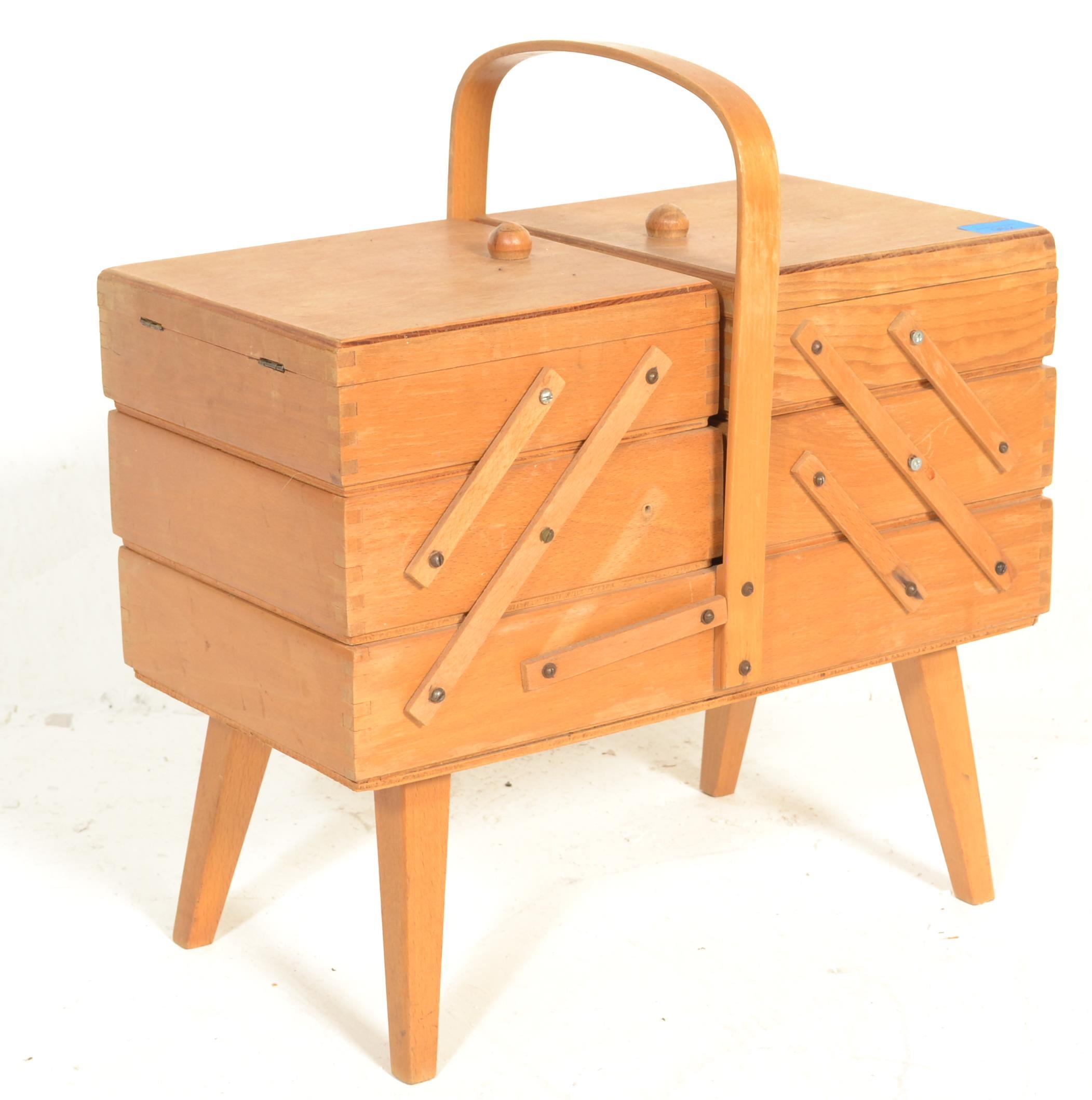 A retro 20th Century cantilever work box / sewing box, carry handle to the top opening to reveal