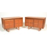 A mid century retro Nathan teak wood pair of side cabinets. Each raised on turned legs with