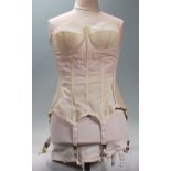 A mid 20th Century 1950's corset having ribbed construction with hook and eye fastening with paneled