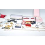 A collection of vintage costume jewellery to include a selection of mid Century brooches, a