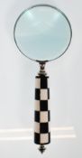 A desktop magnifying glass having a black and whit