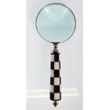 A desktop magnifying glass having a black and whit