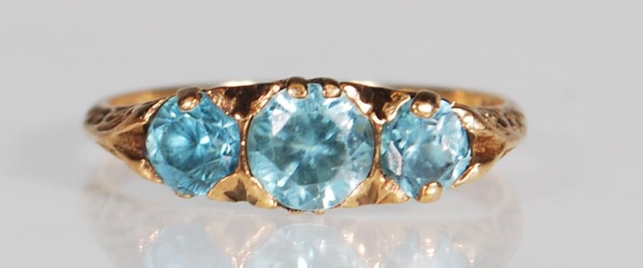 A hallmarked 9ct gold and blue zircon three stone