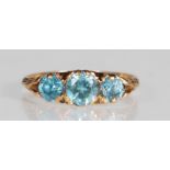 A hallmarked 9ct gold and blue zircon three stone