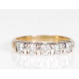 A 9ct gold five stone moissanite ring set on a yel