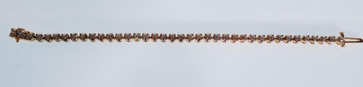 A ladies gold tennis bracelet set with 38 round cu