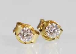 A pair of 18ct gold stud earrings set with brillia