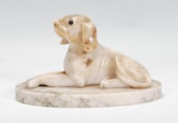 An early 20th century carved stone hound dog model