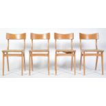 SET OF FOUR BEECH UTILITY DINING CHAIRS RAISED ON A FRAME LEGS