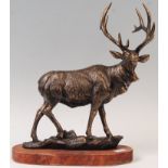 CAST IRON FIGURINE OF A STAG RAISED ON WOODEN BASE
