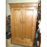 A Continental pine two-door wardrobe, 110cm wide, 180cm high.