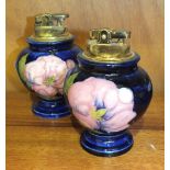Two Moorcroft baluster-shaped blue-glazed table lighters decorated in the Magnolia pattern, 12cm