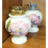 Two Moorcroft baluster-shaped cream-glazed table lighters decorated in the Magnolia pattern, 12cm