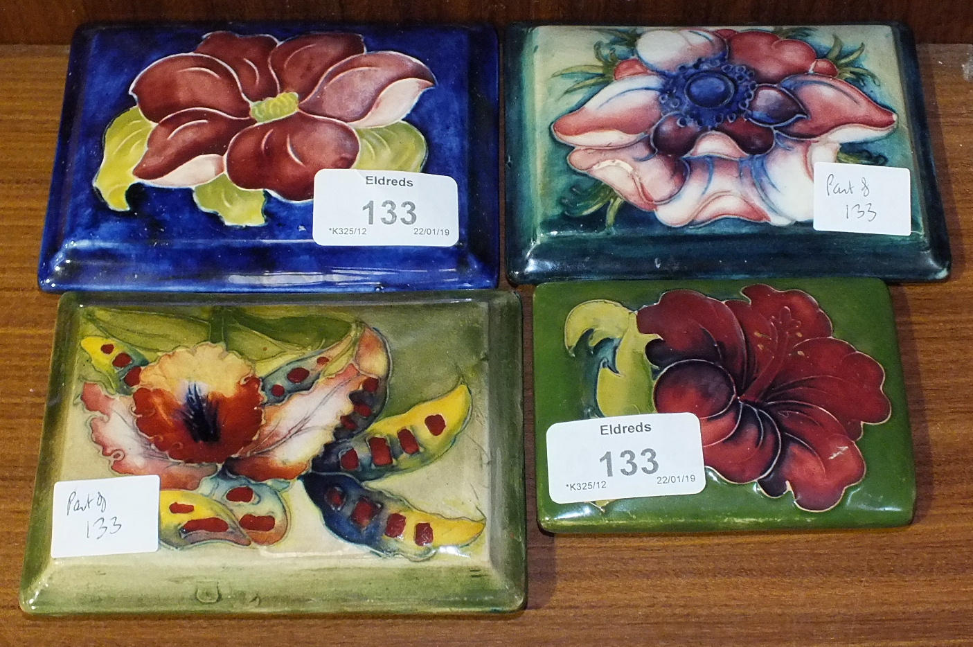 Three Moorcroft rectangular lids, 'Orchid' (green-glazed), 'Anemone' (green/blue-glazed), 'Clematis'