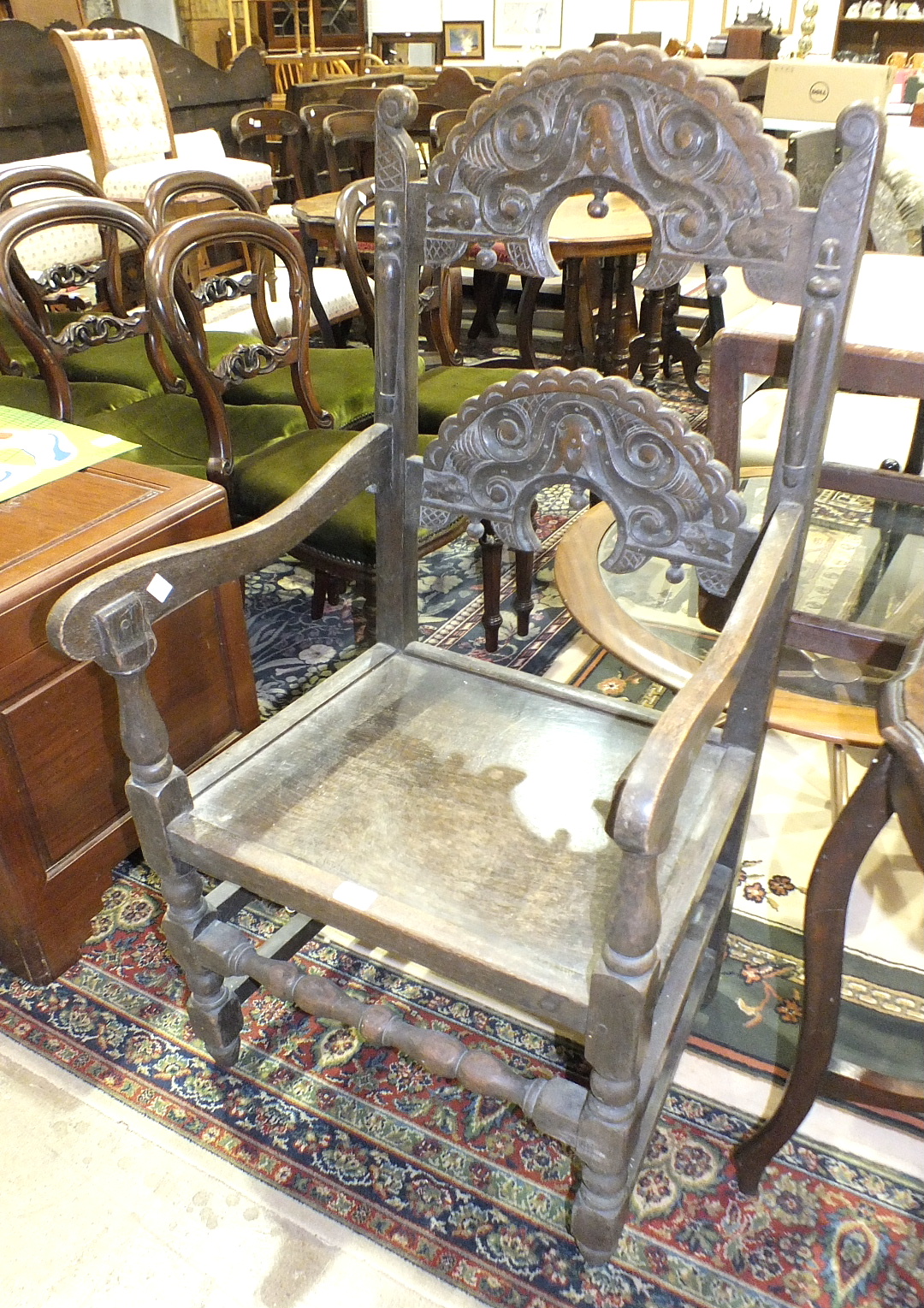 An oak armchair in the Jacobean style, a small Edwardian mahogany fold-over card table and a