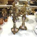 A pair of gilt-metal-mounted ceramic candelabra, one porcelain column broken, 42cm high.