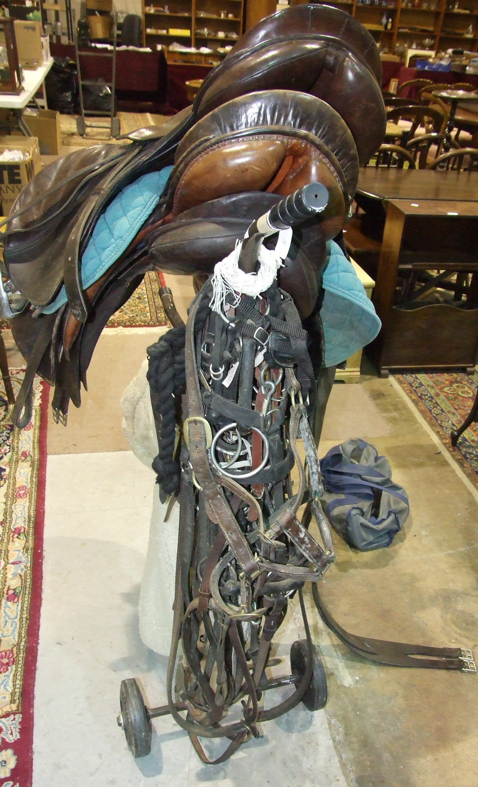 Three leather saddles, miscellaneous bridles and a metal saddle stand. - Image 4 of 4