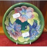 A Moorcroft green-glazed shallow dish decorated in the Clematis pattern, impressed factory marks,