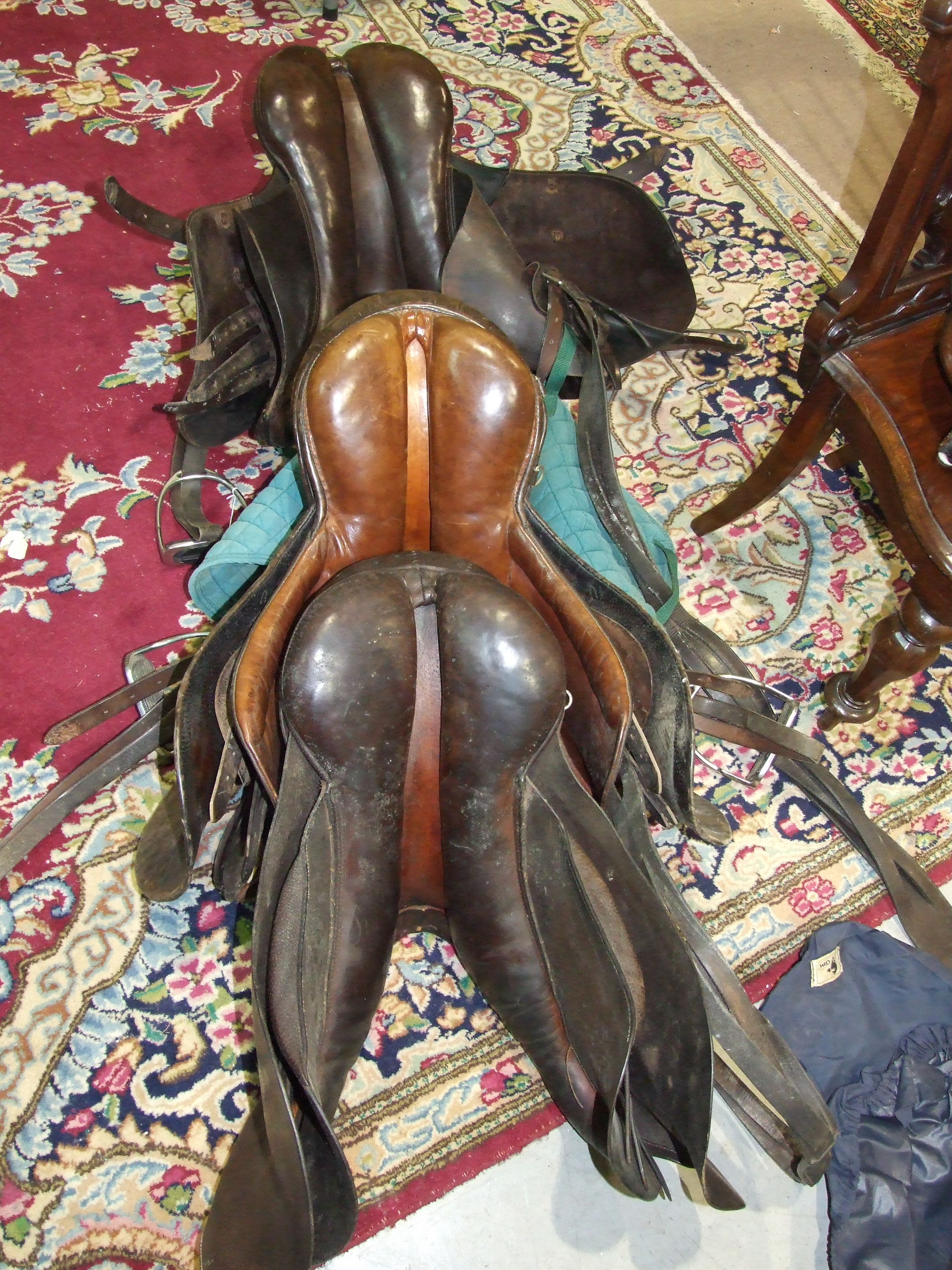 Three leather saddles, miscellaneous bridles and a metal saddle stand. - Image 2 of 4