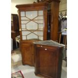 An antique oak corner cupboard having a glazed door above a pair of panelled doors, 215cm high, 94cm