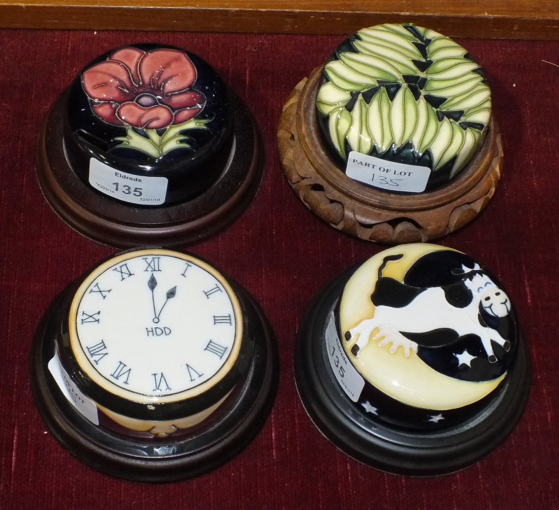 A Moorcroft ginger jar cover, 'Cow jumped over the moon' and three others, mounted on wood, 8cm