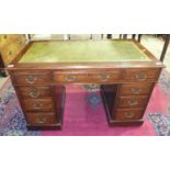 An early-20th century mahogany knee-hole desk, the rectangular top with writing inset and three